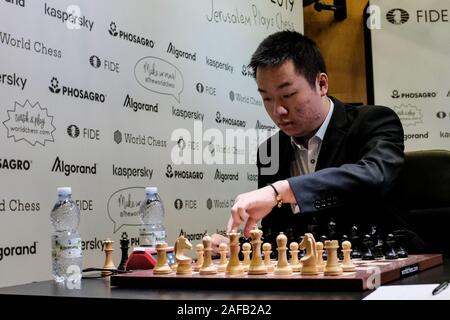 Jerusalem, Israel. 14th December, 2019. WESLEY SO (L), 27, of the USA,  competes with IAN NEPOMNIACHTCHI (R), 29, of Russia, in Round 2, Game 1, of  the final leg of the World