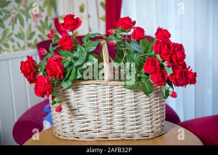 Flower Shop. Valentines Day . red artificial flowers are in the basket.Red roses Artificial Flowers selling in a basket. Stock Photo