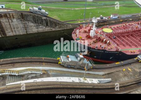 Panama - 11/6/19: A view of a oil chemical freighter ship called the Ardmore Seahawk eing pulled through the Panama Canal by train locomotives called Stock Photo