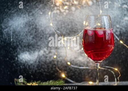 Cognac in glasses on a dark background. Near tangerines. Festive mood. Copy space. Stock Photo