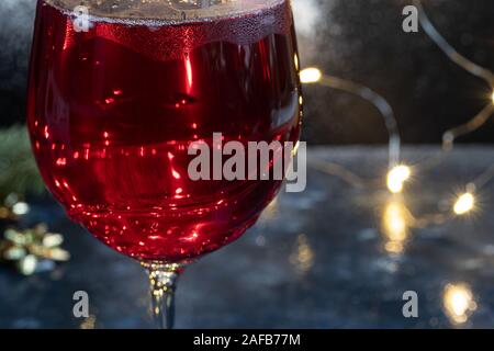 Cognac in glasses on a dark background. Near tangerines. Festive mood. Copy space. Stock Photo