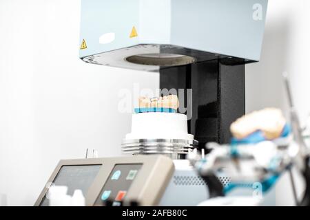 Professional oven with artificial jaw, baking enamel dentures at the laboratory Stock Photo