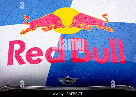 Uzhhorod, ukraine - 14 JUL, 2013: Red Bull mini cooper publicity car logo. fancy car tuning used for promotion. wet advertisement vehicle after the ra Stock Photo