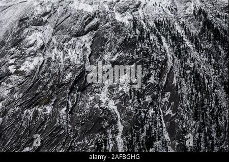 Close-up Weathered rocky mountain with snow pattern on texture Stock Photo