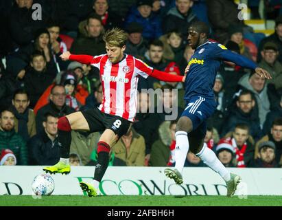 London, UK. 14th Dec, 2019. Brentford's Mathias Jensen and Fulham's Aboubakar Kamara during the Sky Bet Championship match between Brentford and Fulham at Griffin Park, London, England on 14 December 2019. Photo by Andrew Aleksiejczuk/PRiME Media Images. Credit: PRiME Media Images/Alamy Live News Stock Photo