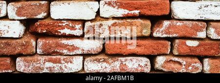 Old brick wall with large gaps between bricks with shabby whitewash Stock Photo