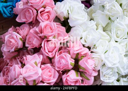 Pink and white fake roses. Made of textile material. Stock Photo