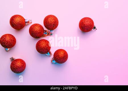 red christmas balloons with glitter on pink background Stock Photo