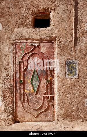 A metal door offers security to a house in the old Mellah district of Marrakesh in Morocco. Stock Photo