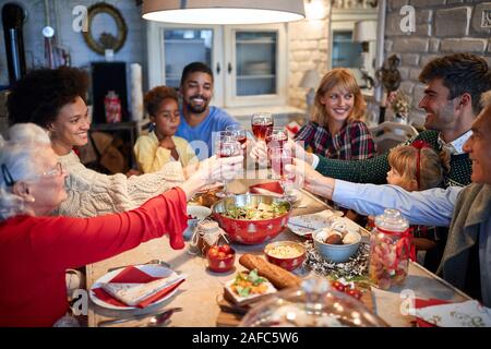 Celebrating Christmas with red wine, concept of family Stock Photo