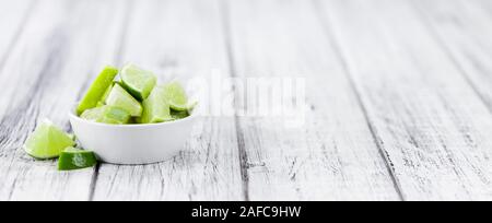 Sliced Limes on an old wooden table as detailed close-up shot (selective focus) Stock Photo