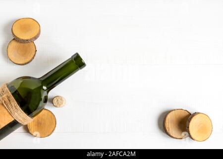 Frame for banner with a bottle of wine. Bottle with wine on a white wooden background. Festive background with place for copy space. Stock Photo