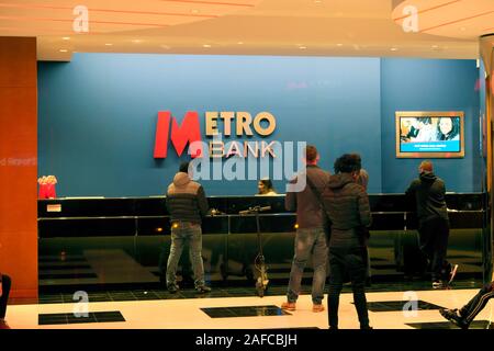 Customers queuing people queue at counter inside Metro Bank interior in City of London England UK  KATHY DEWITT Stock Photo