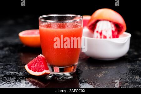 Slate slab with freshly squeezed Grapefruit Juice (selective focus; close-up shot) Stock Photo