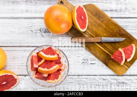 Portion of sliced Grapefruits on an old wooden table (selective focus; close-up shot) Stock Photo