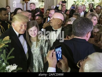 Washington, United States Of America. 12th Dec, 2019. President Donald J. Trump poses for photos with guests during the Congressional Ball Thursday, Dec. 12, 2019, in the Grand Foyer of the White House. People: President Donald J. Trump Credit: Storms Media Group/Alamy Live News Stock Photo