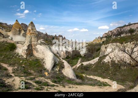 A view from the base of Pigeon Valley at Uchisar in the Cappadocia region of Turkey. Abandoned ancient fairy chimney cave homes can be seen. Stock Photo