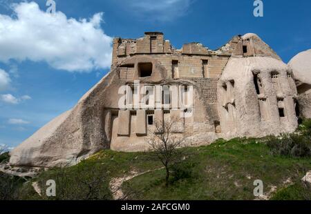 An abandoned ancient cave home which had been carved  in the rock cliff face of Pigeon Valley at Uchisar in the Cappadocia region of Turkey. Stock Photo