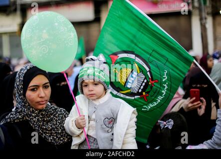 A kid with a Hamas headband while holding a balloon during a rally marking the 32nd anniversary of the founding of the Islamist movement Hamas. Stock Photo