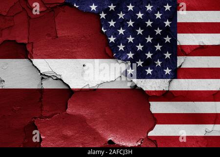 flags of Latvia and USA painted on cracked wall Stock Photo