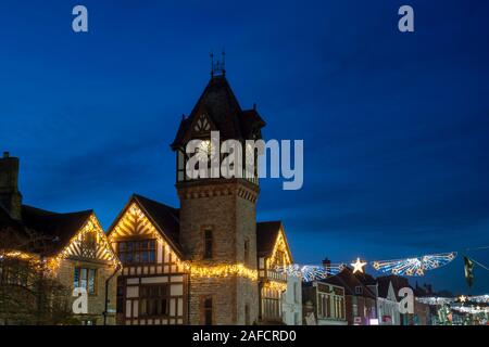 The Barrett Browning Memorial Institute clock tower and library building with christmas lights in the evening. Ledbury, Herefordshire, England Stock Photo