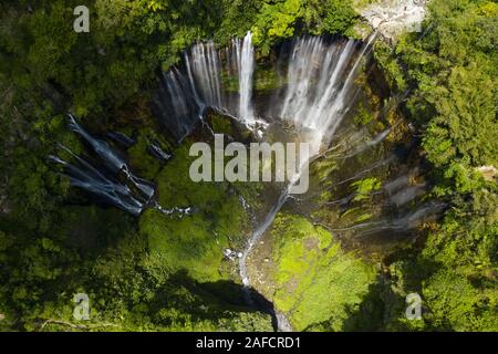 View from above, stunning aerial view of the Tumpak Sewu Waterfalls also known as Coban Sewu. Tumpak Sewu Waterfalls are a tourist attraction in East Stock Photo