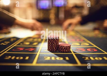 Roulette chips on a gaming table in a casino. Stock Photo