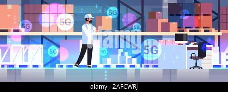 worker carrying cardboard box 5G online wireless communication concept modern warehouse interior horizontal full length vector illustration Stock Vector