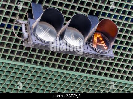 Traffic signal light at tollgate of the tollway. Orange color 'A' symbol in LED traffic light. Traffic equipment. Traffic signal light hang on ceiling ove Stock Photo