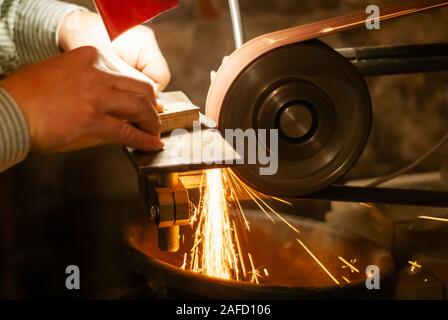 knife sharpening machine and master. Grinding machine. grinding knife using  abrasive stone Stock Photo - Alamy