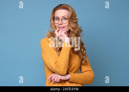 Attractive smiling elegant woman with long hair and glasses with folded hands Stock Photo