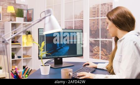Over the shoulder shot of female game developer working on a new project. Stock Photo
