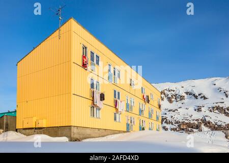 Arctic living residential house with snow hill in the background,  Ilulissat city, Greenland Stock Photo