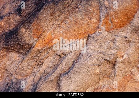Detail of typical wall stone of an ancient Italian house, carved from hand-made rock, eroded and consumed by time. Stock Photo