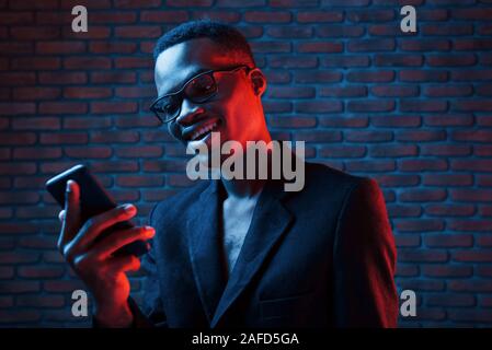 Futuristic neon lighting. Young african american man in the studio Stock Photo