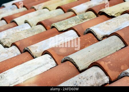 Closeup of an old house roof with a terracotta tiles (clay). Italy, Europe Stock Photo
