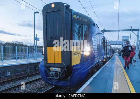 Glasgow, Scotland, UK. 15th December 2019. Robroyston, Glasgow’s 60th train station opens for passenger use. The first train to arrive was the 0826 Glasgow Queen Street high level service to Cumbernauld. This unstaffed station is situated near the Glasgow North Retail Park and serves the route from Glasgow Queen Street to Edinburgh via Cumbernauld and is located between Springburn and Stepps. Credit: Garry Cornes/Alamy Live News Stock Photo