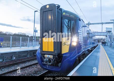 Glasgow, Scotland, UK. 15th December 2019. Robroyston, Glasgow’s 60th train station opens for passenger use. The first train to arrive was the 0826 Glasgow Queen Street high level service to Cumbernauld. This unstaffed station is situated near the Glasgow North Retail Park and serves the route from Glasgow Queen Street to Edinburgh via Cumbernauld and is located between Springburn and Stepps. Credit: Garry Cornes/Alamy Live News Stock Photo