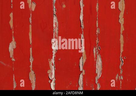 Vintage weathered wooden wall under sunlight, the paint is peeled off Stock Photo
