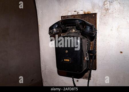 old black crank telephone II world war inside bunker Stock Photo