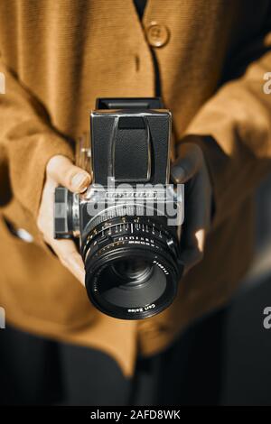 Chiang Mai, Thailand - December 10, 2019 : Vintage young hipster girl photographer hand holding retro camera. Stock Photo