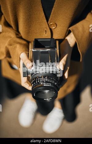 Chiang Mai, Thailand - December 10, 2019 : Vintage young hipster girl photographer hand holding retro camera. Stock Photo
