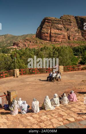 Ethiopia, Tigray, Wukro, Abraha we Atsbeha, C10th church, devotees sat outside after mass Stock Photo