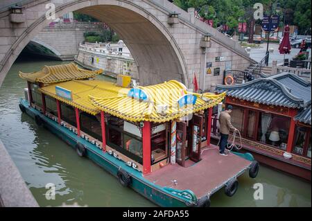 Wuxi, China - October 2019: Tour boat on a canal, part of a network of waterways connected by the Grand Canal - China, which runs through the city Stock Photo