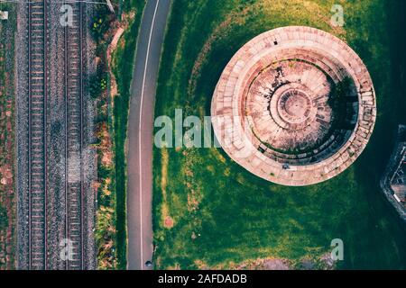 Top-down view Irish small tower and train rails on the coast of Dublin county in Blackrock Stock Photo