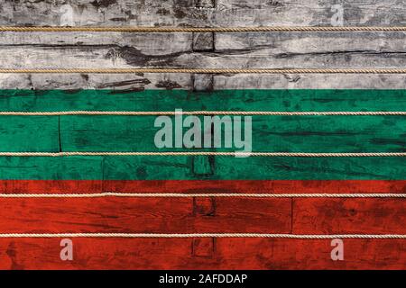 National flag  of Bulgaria  on a wooden wall background. The concept of national pride and a symbol of the country. Flags painted on a wooden fence wi Stock Photo