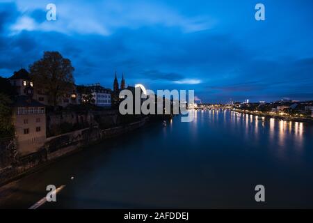 Basel Switzerland at night over the Rhine river. Stock Photo