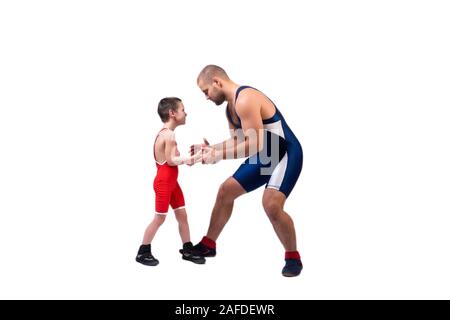 Men in wrestling tights and wrestlers holds the foot of a wrestler boy on a  white isolated background. Dad and son have been fooling around forever.Te  Stock Photo - Alamy