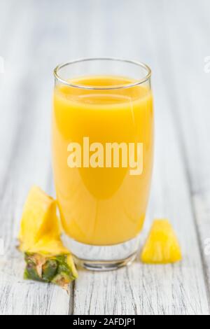 Homemade Pineapple Juice on vintage background selective focus; close-up shot Stock Photo