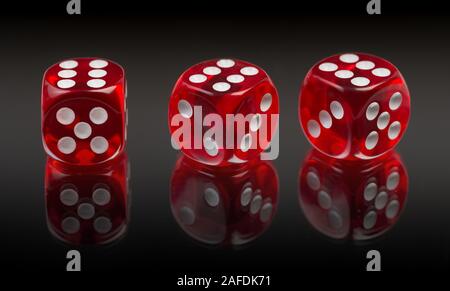 Red dices on gradient black mirror background Stock Photo